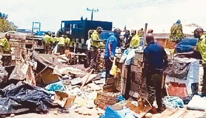 In a recent enforcement operation, the Lagos State Environmental Sanitation Corps apprehended two traders as they demolished shops along Akiogun Road