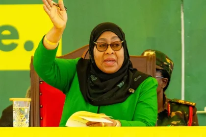 President Samia Suluhu Hassan waving to supporters after winning Tanzania’s 2025 general election, as security forces patrol streets following deadly post-election protests.