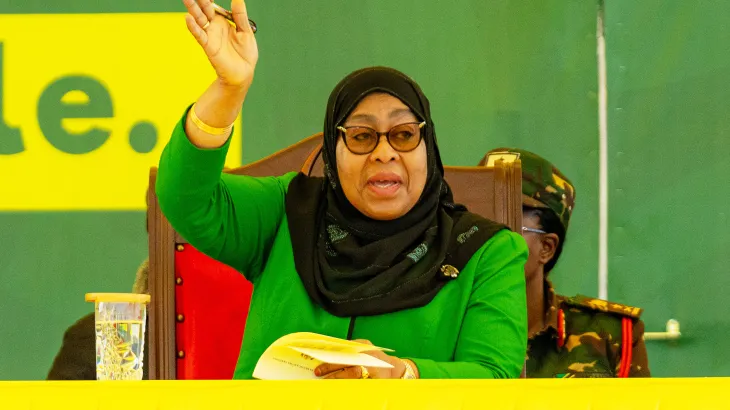 President Samia Suluhu Hassan waving to supporters after winning Tanzania’s 2025 general election, as security forces patrol streets following deadly post-election protests.
