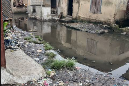 Thick smoke from burning refuse and vehicle exhaust fills the air in a busy Lagos street, highlighting worsening air pollution in the city.