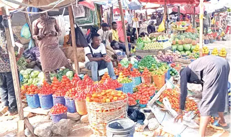 Residents shopping for food at an Abuja market amid declining prices but persistent affordability challenges.
