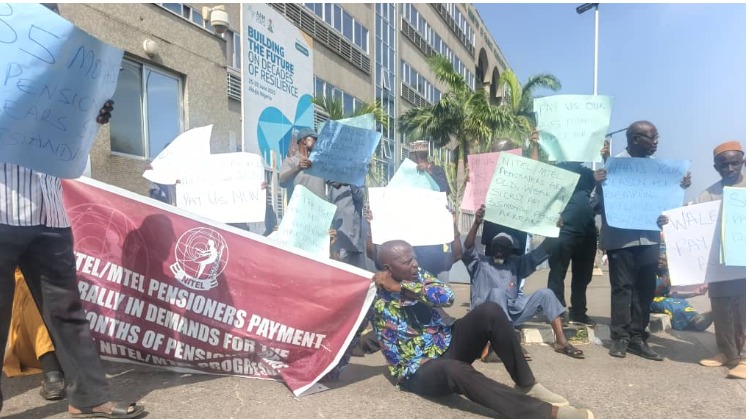 Elderly pensioners sitting on the floor demanding payment of arrears