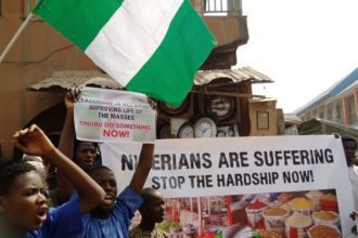 Residents of Abuja are increasingly struggling to cope with rising living costs, as a monthly income of ₦300,000—once considered comfortable—loses its purchasing power. Amid persistent inflation and rising fuel prices, many workers in the Federal Capital Territory say their salaries are now barely sufficient to cover basic needs, leaving little or nothing for savings. For civil servants and private sector employees alike, monthly earnings are largely consumed by fixed expenses such as rent, transportation, and food, forcing households into a cycle of financial strain. “We don’t really eat like before. Meat is now occasional. You plan meals like a budget document,” said Grace Utaru, a civil servant in Abuja. Another resident, Abdulrasak Babandede, who commutes from Suleja, described the situation as overwhelming. According to him, by the time rent and transport costs are settled, little remains from his income. The rising cost of housing remains one of the biggest financial pressures. In areas such as Lugbe, Kubwa, and Gwarinpa, annual rent for a modest one-bedroom apartment ranges between ₦800,000 and ₦1.5 million. When broken down monthly, rent alone can take up as much as 40 percent of a worker’s salary, excluding additional charges like agency fees and service costs. This is further complicated by Nigeria’s upfront rent payment structure, which places heavy financial demands on tenants. Experts say the widening gap between income levels and housing costs is driven by limited supply, high construction costs, and inflationary pressures. Transportation is another major burden. Workers commuting daily from satellite towns to business districts report spending between ₦40,000 and ₦60,000 monthly on transport, largely due to rising fuel prices. Energy costs also continue to climb. With unreliable public power supply, many households now spend between ₦30,000 and ₦70,000 monthly on electricity and generator fuel. Food inflation has added to the pressure. A family of four now spends between ₦120,000 and ₦180,000 monthly on food, forcing many households to cut back on protein and adopt cheaper meal options. Development economists warn that when essential expenses—housing, food, transport, and energy—consume the bulk of income, households are left with little capacity to save or withstand financial shocks. This comes despite recent government efforts to improve wages. In 2024, President Bola Ahmed Tinubu approved a ₦70,000 minimum wage, with a promise of periodic review. However, data from the National Bureau of Statistics shows that inflation remains elevated, eroding real income and weakening purchasing power across the country. Analysts say unless inflation slows significantly and wages adjust accordingly, more urban households could slip deeper into financial vulnerability. The situation highlights a growing reality in Nigeria’s cities: earning what was once considered a stable income is no longer enough to guarantee financial security.